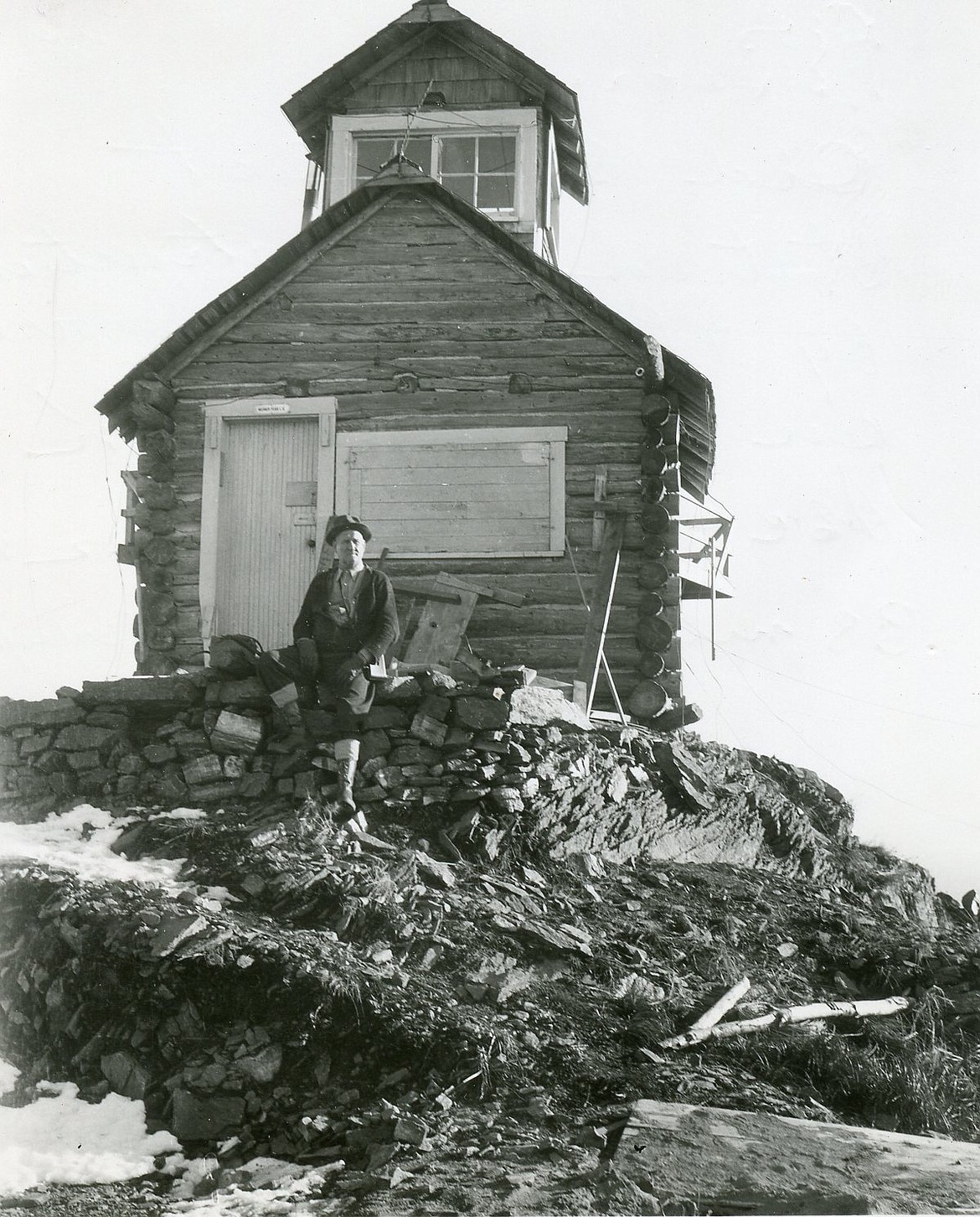A.E. Boorman rests outside the old Werner Peak Lookout 38 miles north of Kalispell in October 1941. (M.E. Boorman photo)