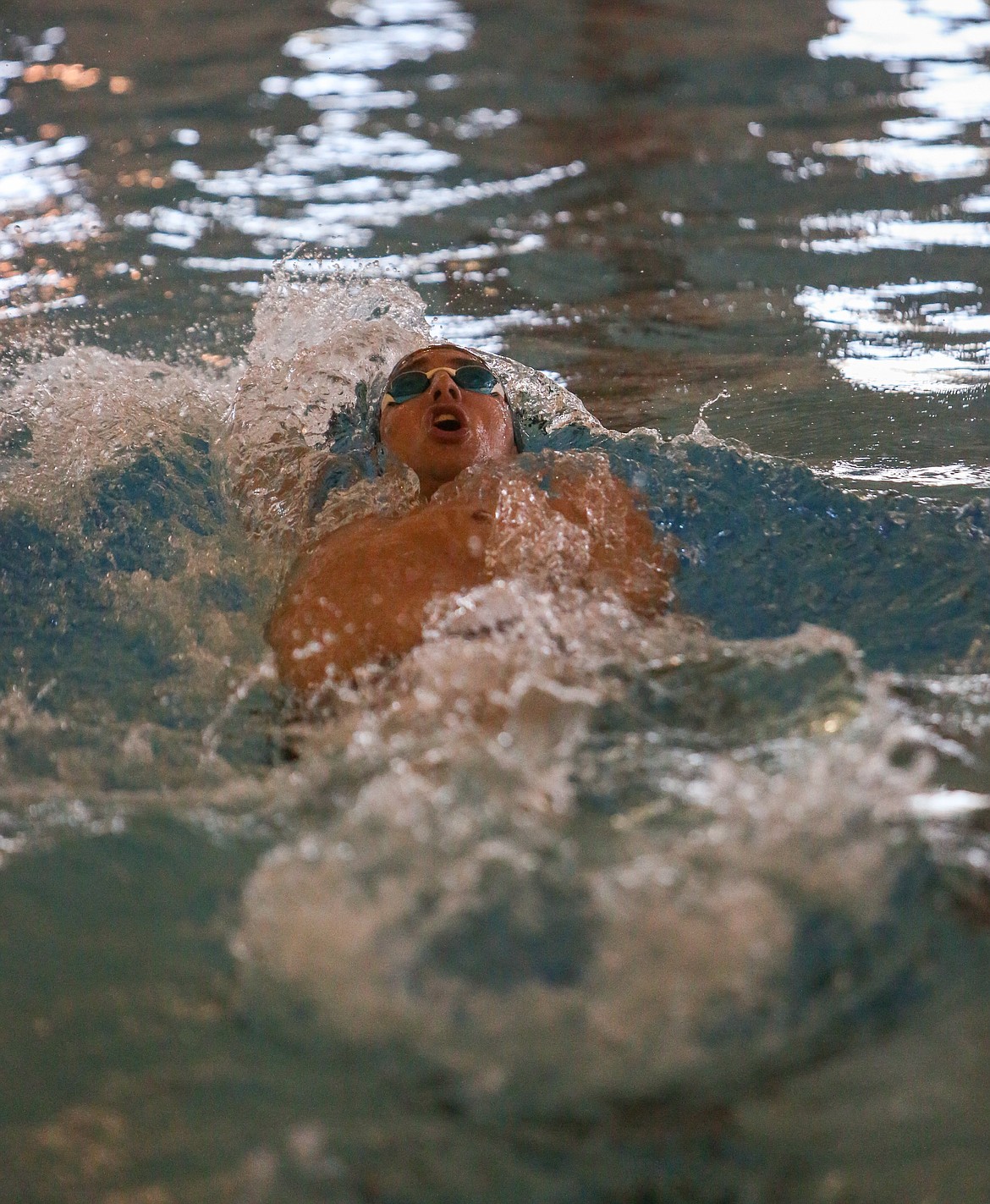 Moses Lake High School senior Zach Washburn makes his way back down the pool in the final heat of the 100 yard backstroke event on Thursday afternoon in Moses Lake.