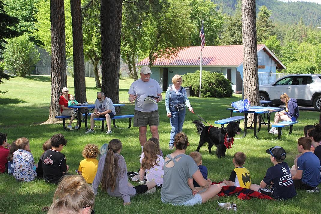 Dan and Barbara Arnsan teach attendees about their flatcoated retriever, Ranger, at “Tails and Tales” at the Superior branch of the Mineral County Library. It was the first in the summer series which will run through July. (Monte Turner/Mineral Independent)