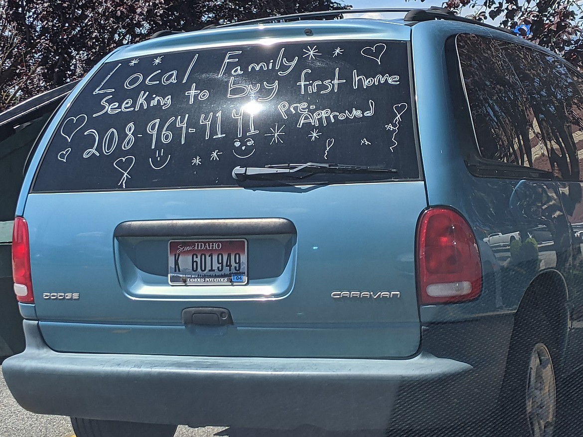 A local family advertises on the back window of their van hoping to buy their first-time home, Thursday, in the Wendy's parking lot in Post Falls.