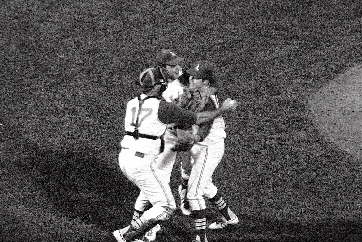 Associated Press
Oakland Athletics pitcher Jim "Catfish" Hunter, right, is congratulated by catcher Jim Pagliaroni and third baseman Sal Bando, center, on the pitcher's mound after Hunter pitched a perfect game against the Minnesota Twins on May 8, 1968, in Oakland.