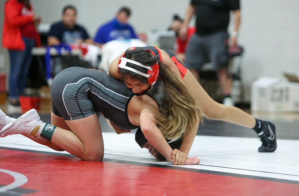 Othello High School's Crystal Elizarraraz looks to gain control in the final matchup of the day for the senior versus Emely Arreola of Davis on Thursday afternoon in Othello.