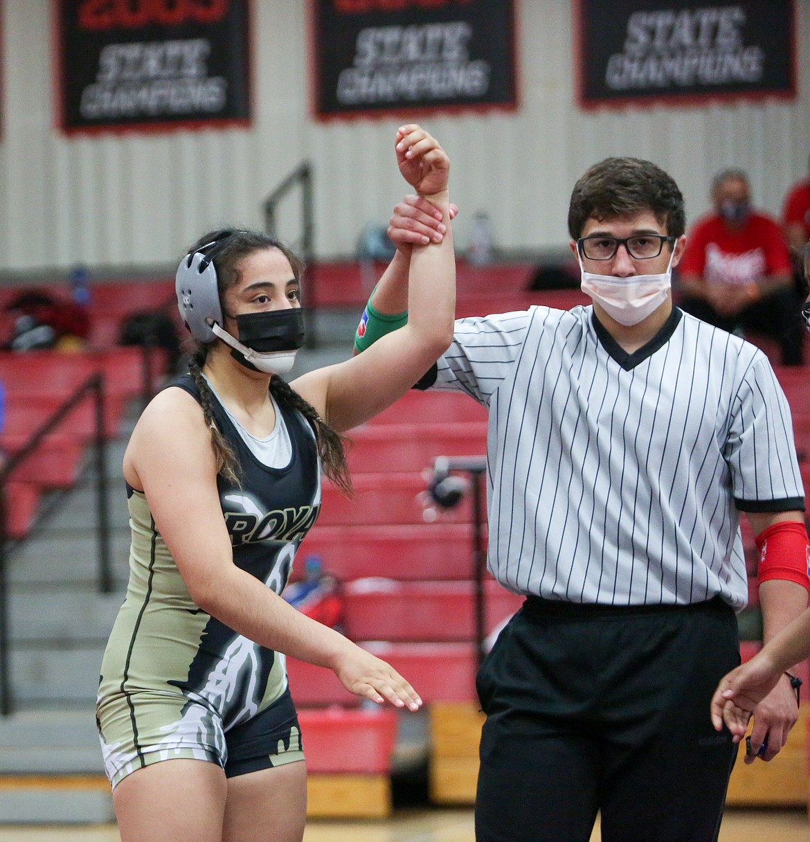 Royal High School freshman Emma Villa's hand is held up after a victory in one of the opening rounds at 145 on Thursday afternoon at the girls wrestling event at Othello High School.