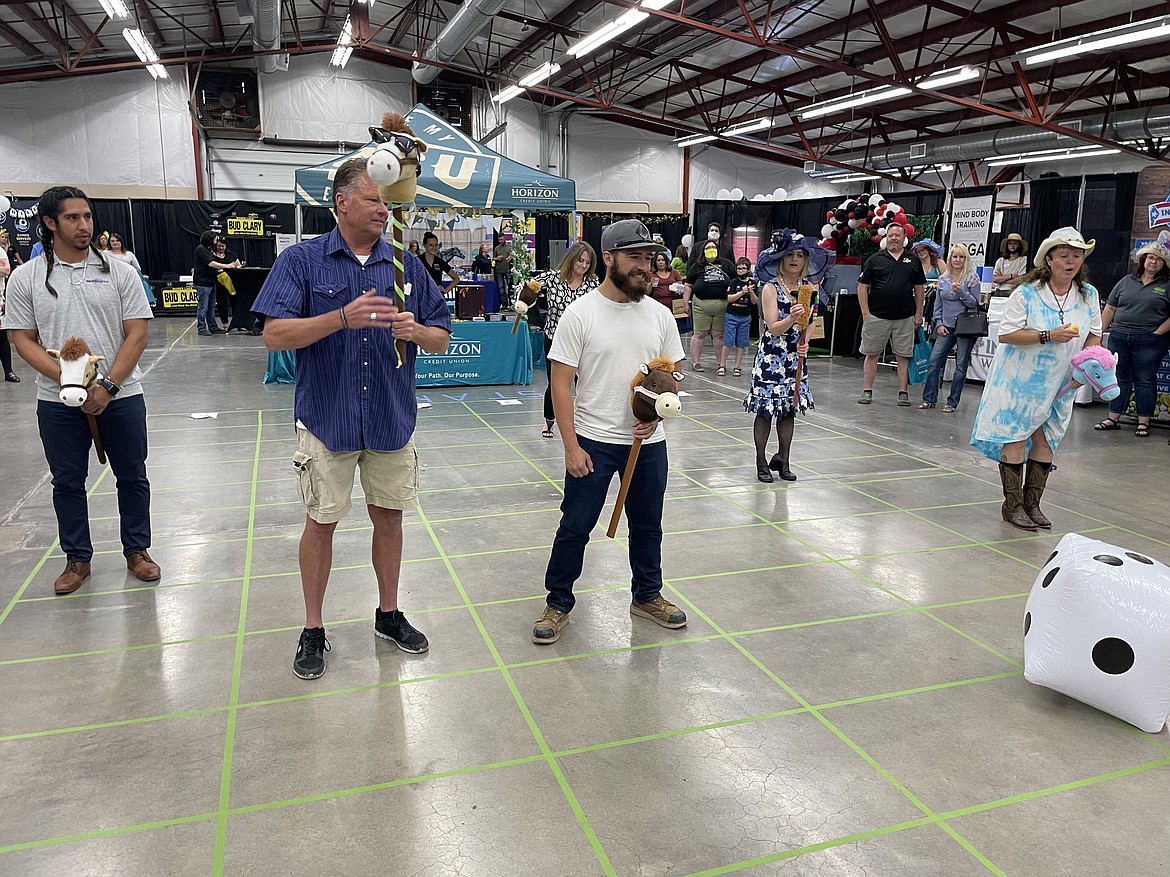 “Racers” Esteban Miron, Rich Victor, Daniel Mende, Danielle Boss, Vicki Rivers and Shannon “Shanbo” Waters near the end of their race held as part of the 2021 Kentucky Derby-themed Moses Lake Business Expo.