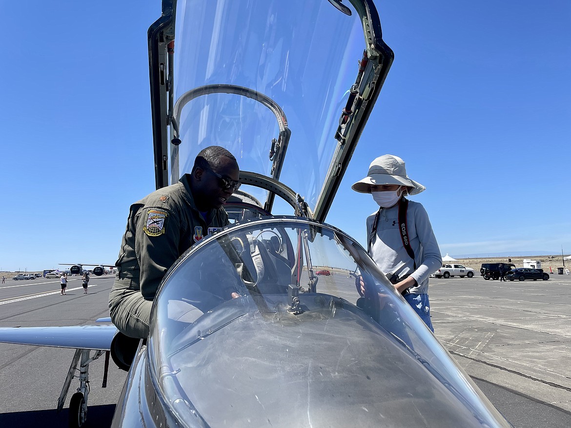 U.S. Air Force U-2 pilot Maj. “Judge” (his call sign) shows 11-year-old Andrew Alvarez from Everett, Washington, how his T-38 trainer works. Judge, who is based out of Beale Air Force Base near Sacramento, said he flies the trainer to keep up on his flying skills because the U-2 spy plane requires a lot of support to fly too frequently.