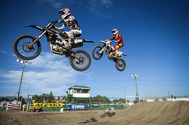Professional riders clear a jump during Top Dawg Arena Cross at the Northwest Montana Fairgrounds in Kalispell on Friday, June 18, 2021. (Casey Kreider/Daily Inter Lake)