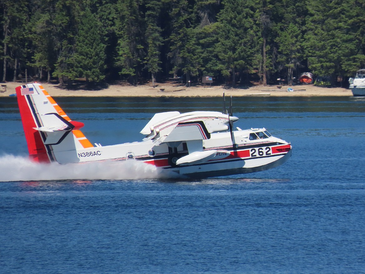 A CL-415 superscooper is fighting the Cedar Grove fire located a half mile over the Washington-Idaho border in Squaw Valley. The blaze was reported on Sunday. Hotshots have been called in to fight the 3.5 acre blaze.