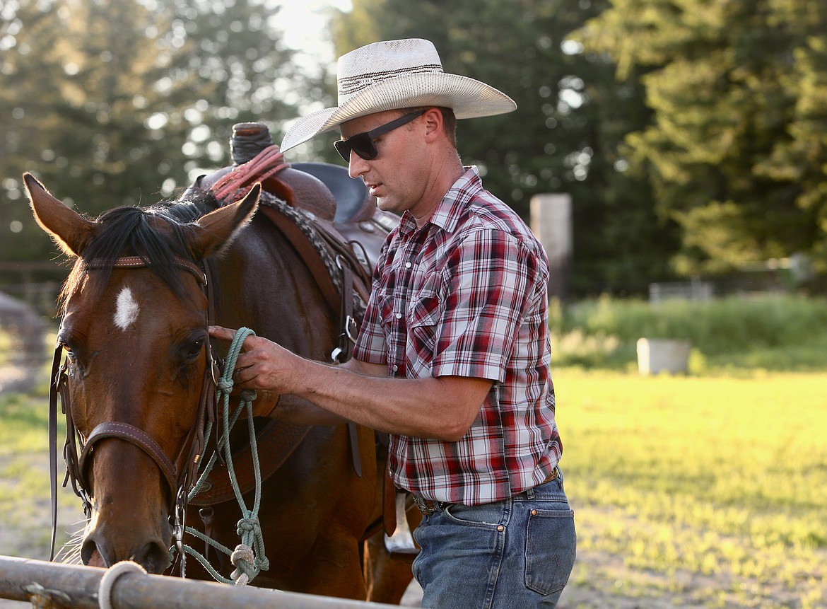 Steve Bodick untacks his horse Sunday evening, June 13. 
Mackenzie Reiss/Bigfork Eagle