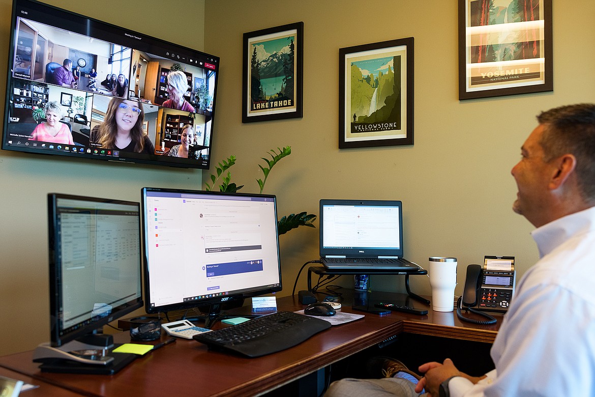 Kevin McClelland meets with coworkers during an online video conference from his Magnuson McHugh & Company P.A. office in Coeur d'Alene.