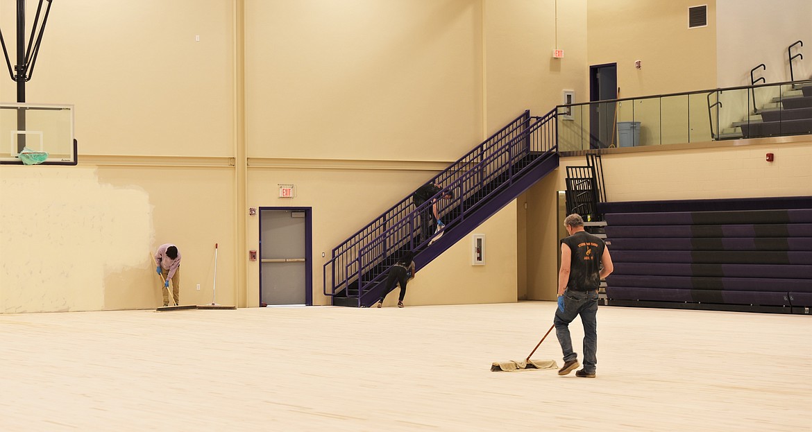 Workers meticulously cleaned the floors of the new gym in late April, before a pirate ship was etched into the center. (Scot Heisel/Lake County Leader)