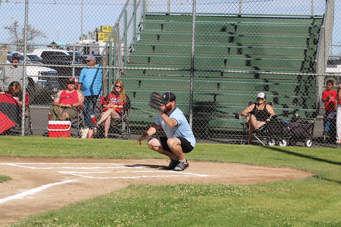 Pete Doumit’s son and former MLB catcher Ryan Doumit catches the ceremonial pitch Saturday morning, kicking off the Pete Doumit Memorial Tournament.