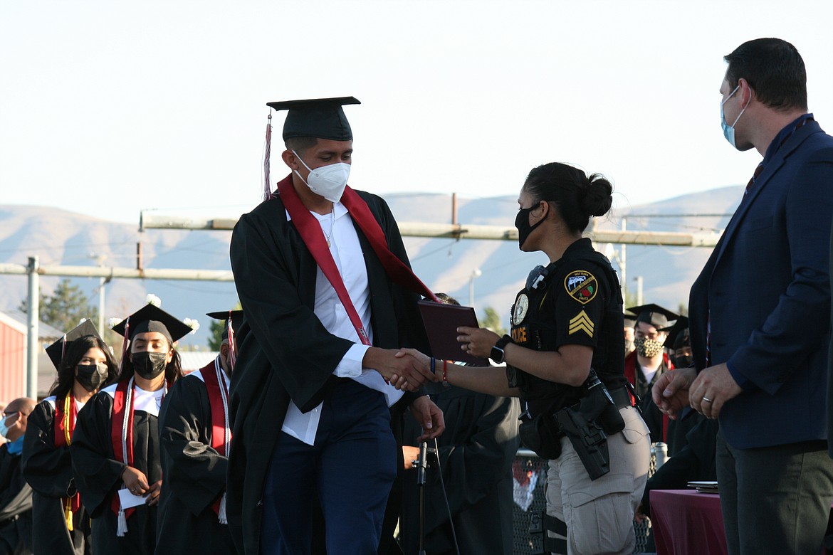 A senior accepts his diploma during Wahluke High School graduation ceremonies in Mattawa June 18.