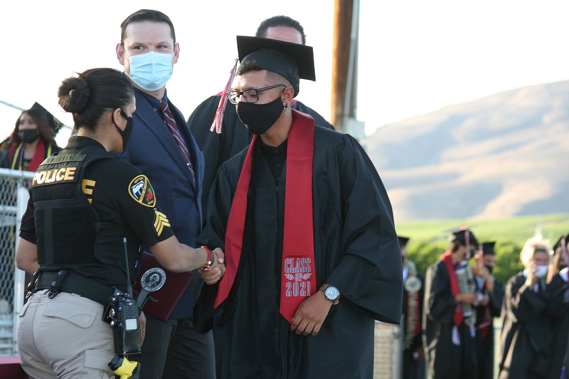 A Wahluke High School graduate accepts his diploma during ceremonies June 18 in Mattawa.