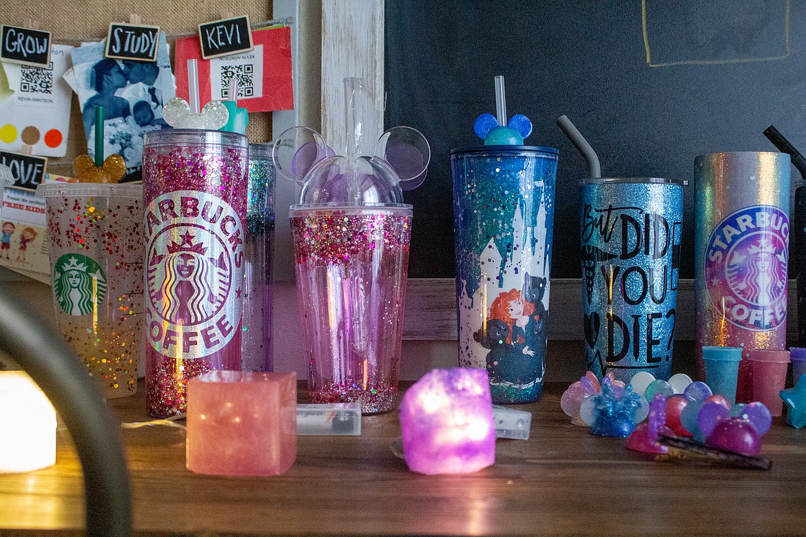 A line of custom-made tumbler cups and water bottles sit on a table in Star Arntson’s kitchen in Moses Lake.