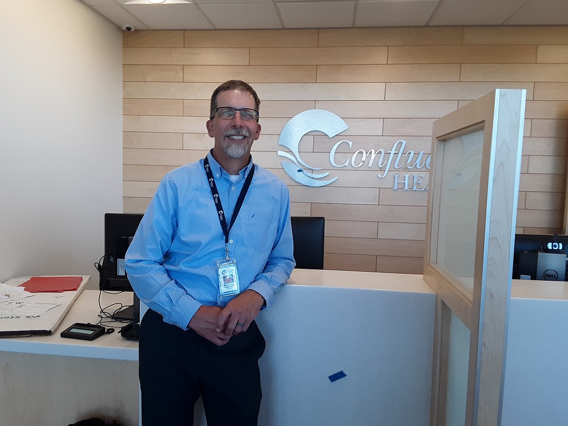 Gregg Fletcher, Confluence Health-Moses Lake Clinic vice president, at the reception desk of the new Confluence Health facility in Moses Lake, scheduled to open Monday.