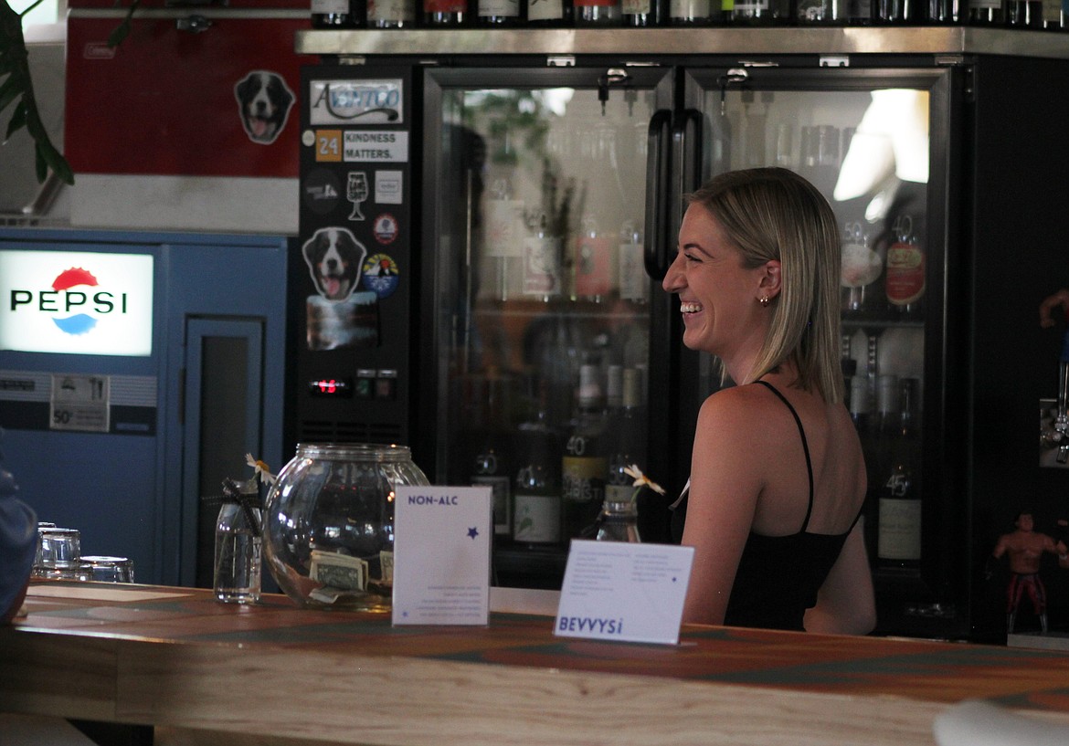 Jacey Lawson serves drinks to guests at Wednesday's beneficiary dinner at the Longshot.