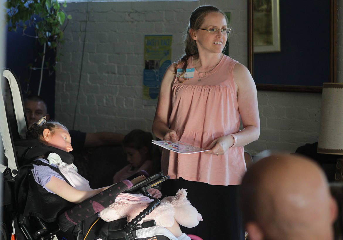 Jessica Rachels discusses the book she wrote from the perspective of her daughter, Natalie, (left) during the beneficiary dinner Wednesday at the Longshot.