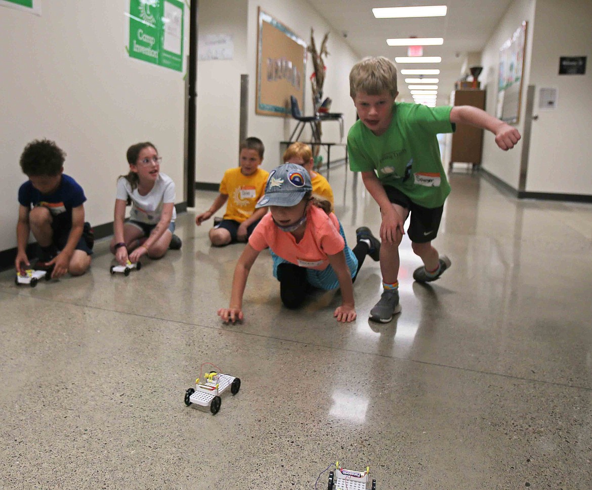 Incoming second-graders Birdie Bailey and Sawyer Glenn prepare race their pulley-powered cars Wednesday during Camp Invention at Northwest Expedition Academy.