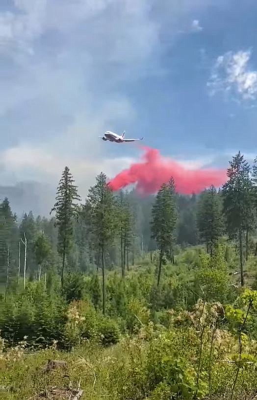 An airplane dumps fire retardant on the Little Pines fire Wednesday.