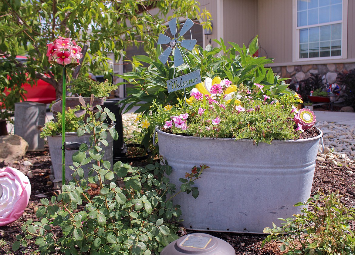 Flowers and repurposed containers fill Valerie Parrott’s garden in Moses Lake.