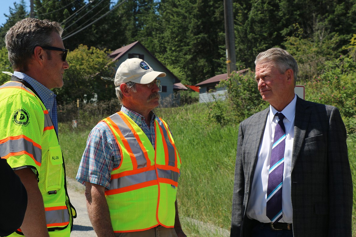 Idaho Gov. Brad Little, right, talks to then Bonner County Road & Bridge Director Steve Klatt, center, and Damon Allen, left, the Idaho Transportation Department's District 1 engineer, right during a June visit to the site of a planned improvement project at U.S. 95 and Lakeshore Drive in Sagle.