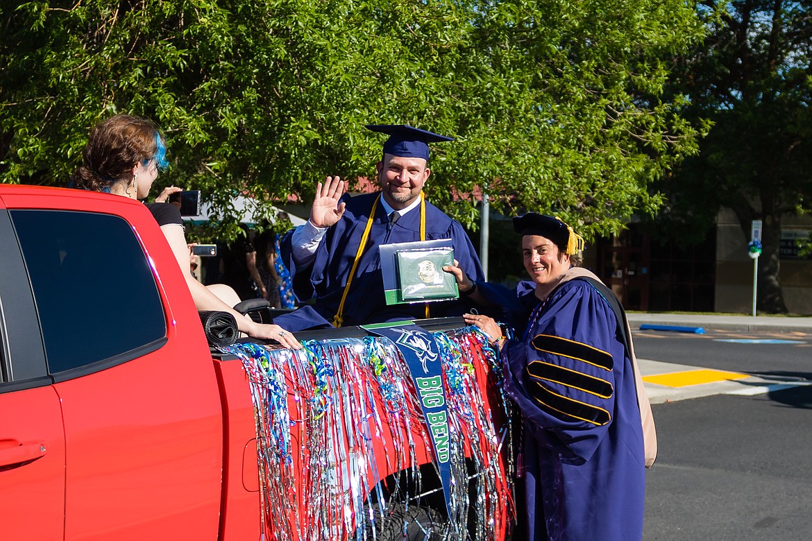 A Big Bend Community College graduate accepts his diploma from BBCC President Sara Thompson Tweedy (right).