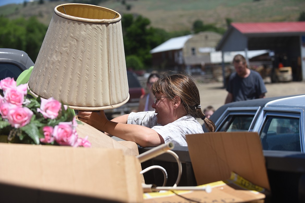 Sandi Lane, of the Plains Womans Club, loads some of the unsold extra items into a truck after their rummage sale at the Plains VFW Hall last Saturday. Fellow member Ellen Childress said it's one of the group's largest fundraisers. The money raised funds a $500 scholarship to a graduating Plains female senior. Childress said the group took on the challenge of refurbishing the old schoolhouse in town, including putting a new roof on it, oiling the logs and power washing it. It's also set to get a new coat of paint this summer. The club will also host Shakespeare in the Park at the end of August. (Scott Shindledecker/Valley Press)