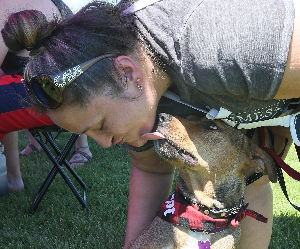 Chentel Morrison of Path of Hope Rescue shares some love with Savannah, an adoptable cattle dog mix, during the Dog Days of Summer-Fest event in Hayden on Saturday.