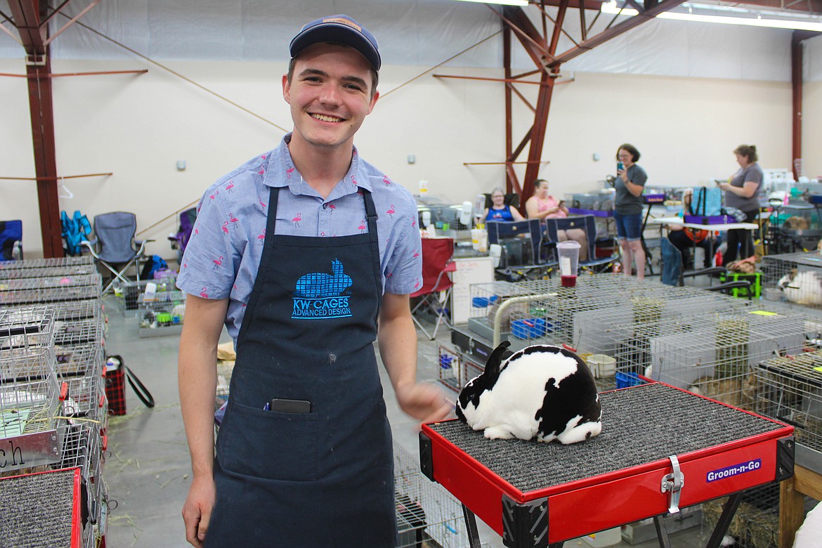 Griffin Harrah stands with his Mini Rex, Double D, at the Washington State Rabbit Breeders Association Convention at the Grant County Fairgrounds on Saturday.