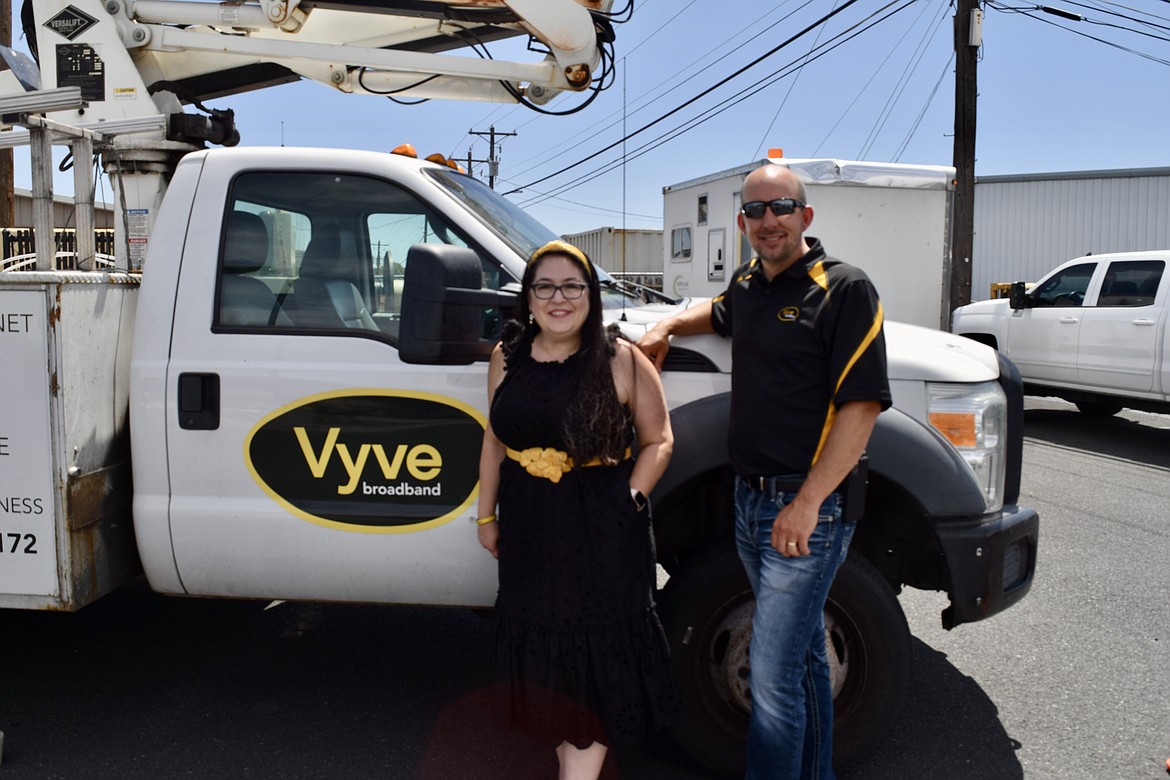 Vyve Broadband Senior Vice President of Marketing and Customer Experience Diane Quennoz, left, and Regional Vice-President Travis Kohlrus stand in front of one of the company’s service trucks in Moses Lake in mid-June. Vyve merged with Northland Communications in November 2019.