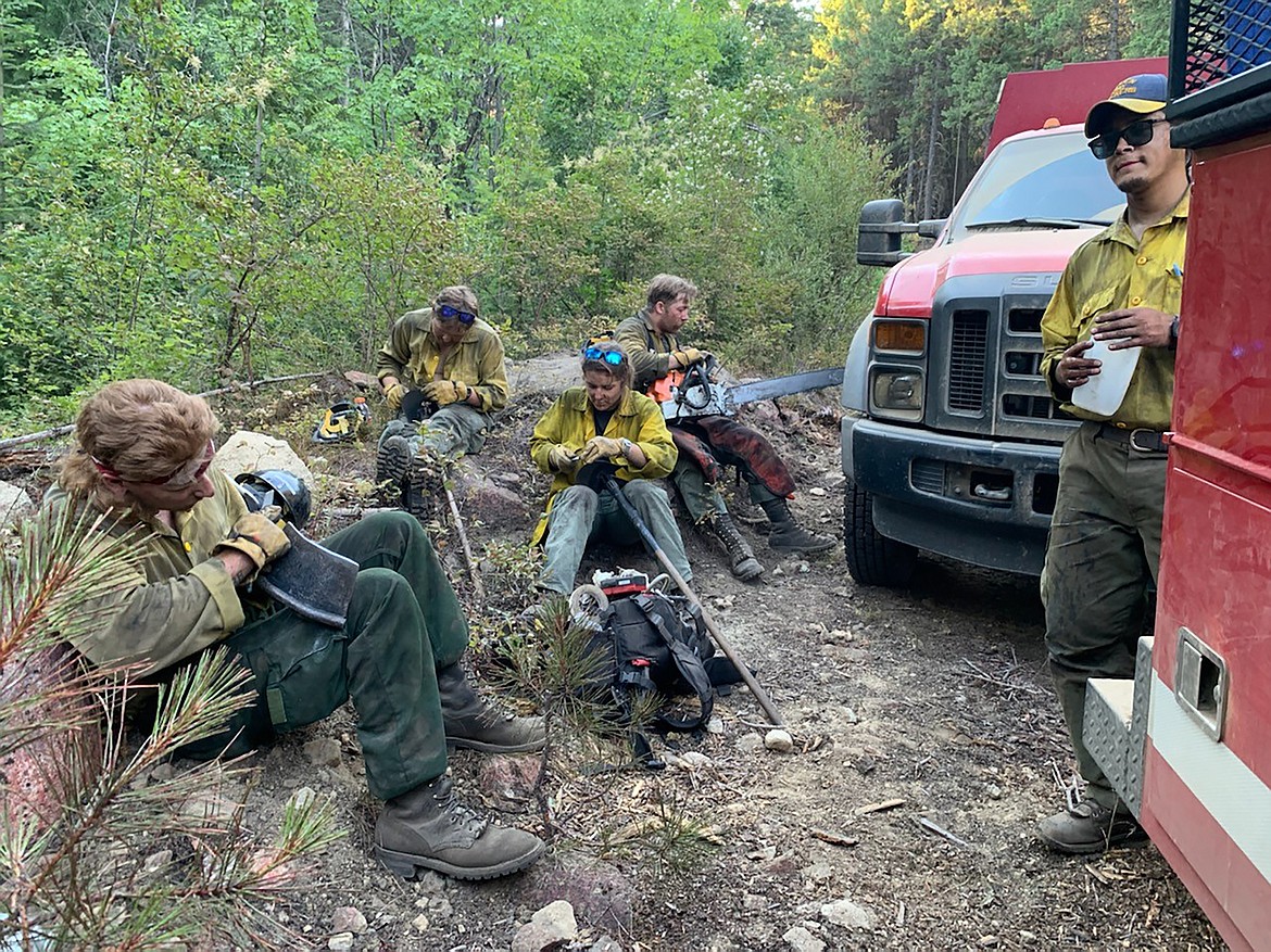 Firefighters take a hard earned break in the shade on the Little Pine Fire this weekend. Water and pacing are essential with the temperatures over the weekend and Monday reaching 100-plus degrees on the hill.