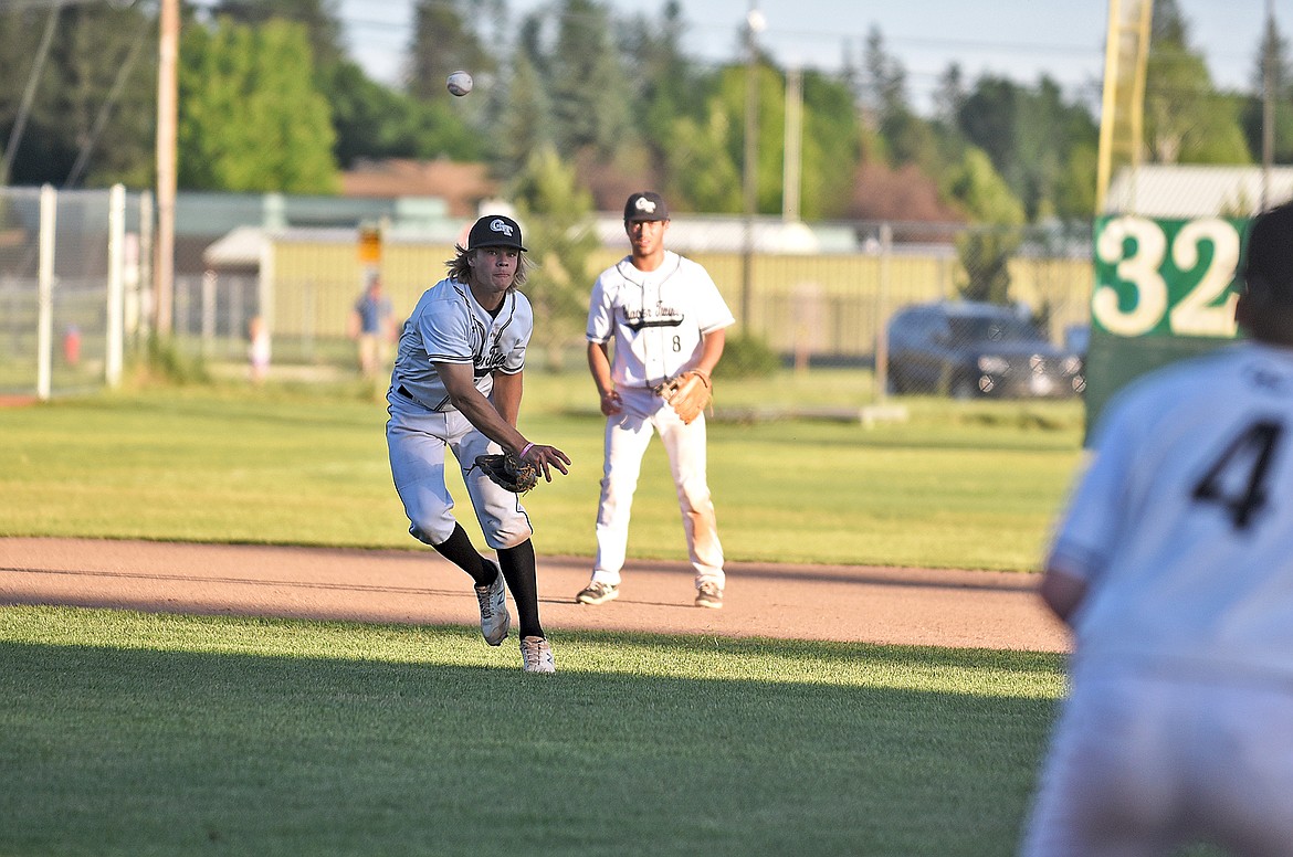 Glacier Twins' Zach Veneman throws the ball to first base in an attempt to tag a runner out in a game against Clark Fork Valley during the Ed Gallo Invitational on Friday in Whitefish. (Whitney England/Whitefish Pilot)
