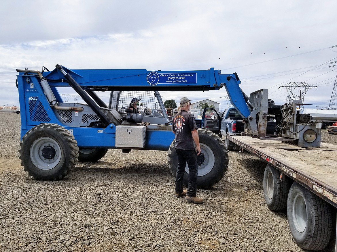 Alexis Mansfield runs a forklift at Chuck Yarbro Auctioneers Inc. in Ephrata.