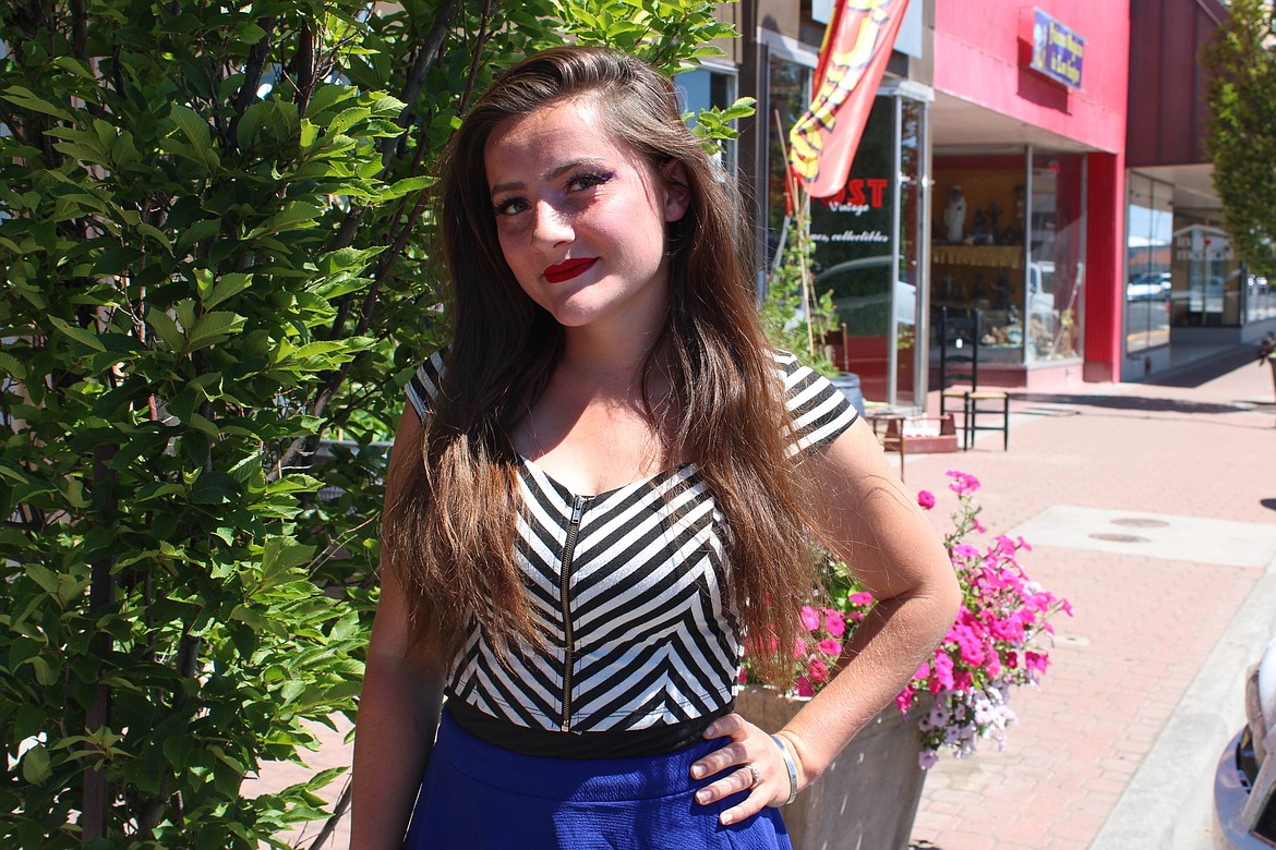 Alexis Mansfield, of Chuck Yarbro Auctioneers Inc., poses in downtown Moses Lake.