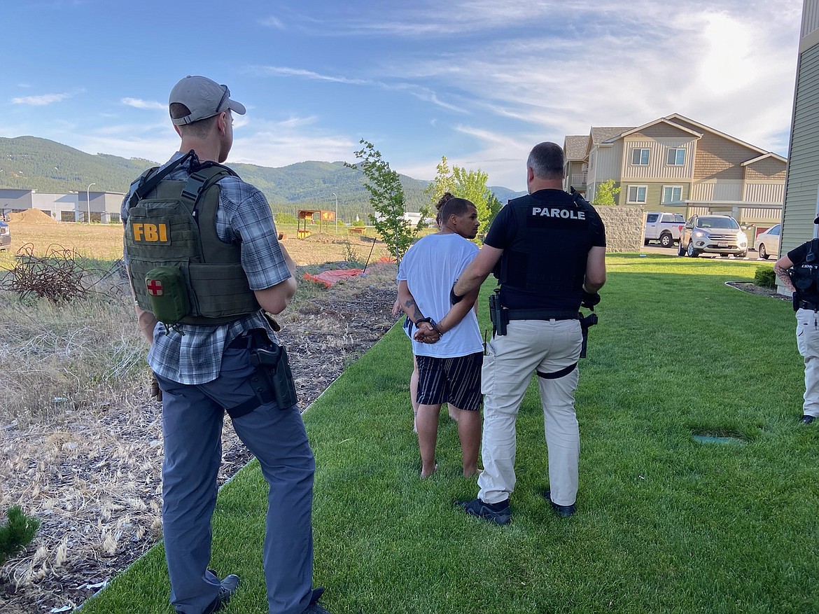 Idaho Probation & Parole and Federal Bureau of Investigation personnel take a suspect into custody during Operation Safe Streets for a probation violation warrant.