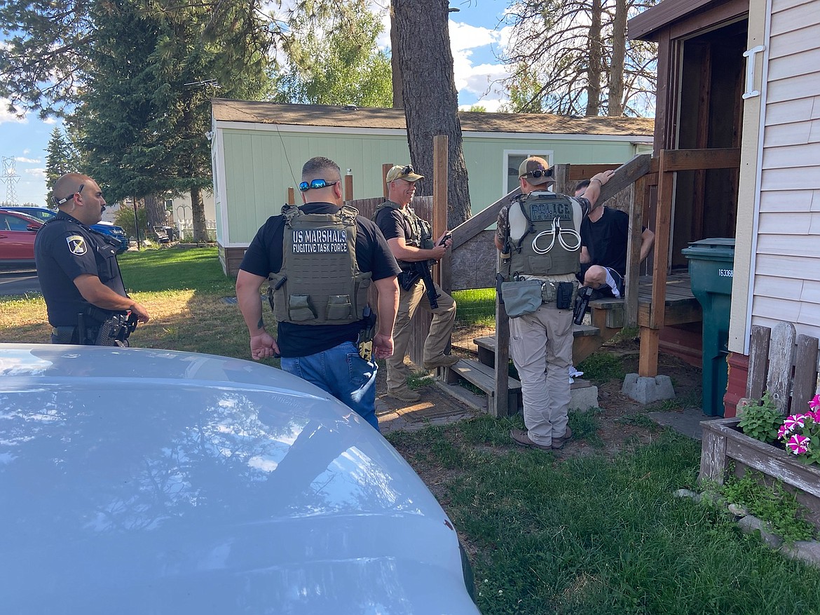 Idaho State Police, U.S. Marshals, and Post Falls Police detain a suspect in Post Falls for an outstanding warrant during the operation.