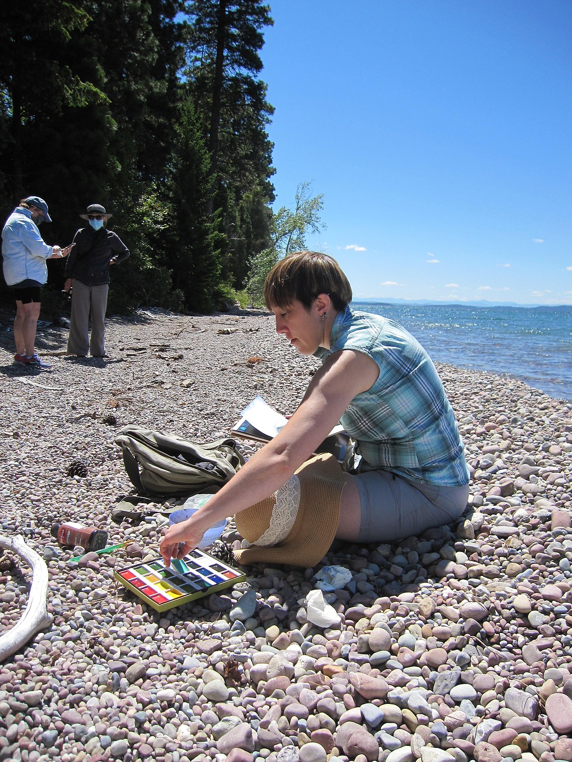 An artist paints en plein air on the shore of Flathead Lake during last year's Plein AIR at the Flathead Lake Biological Station event.