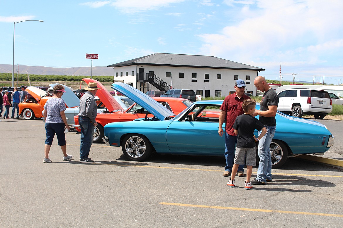 Visitors take in the car show during Summerfest 2019 in Royal City.