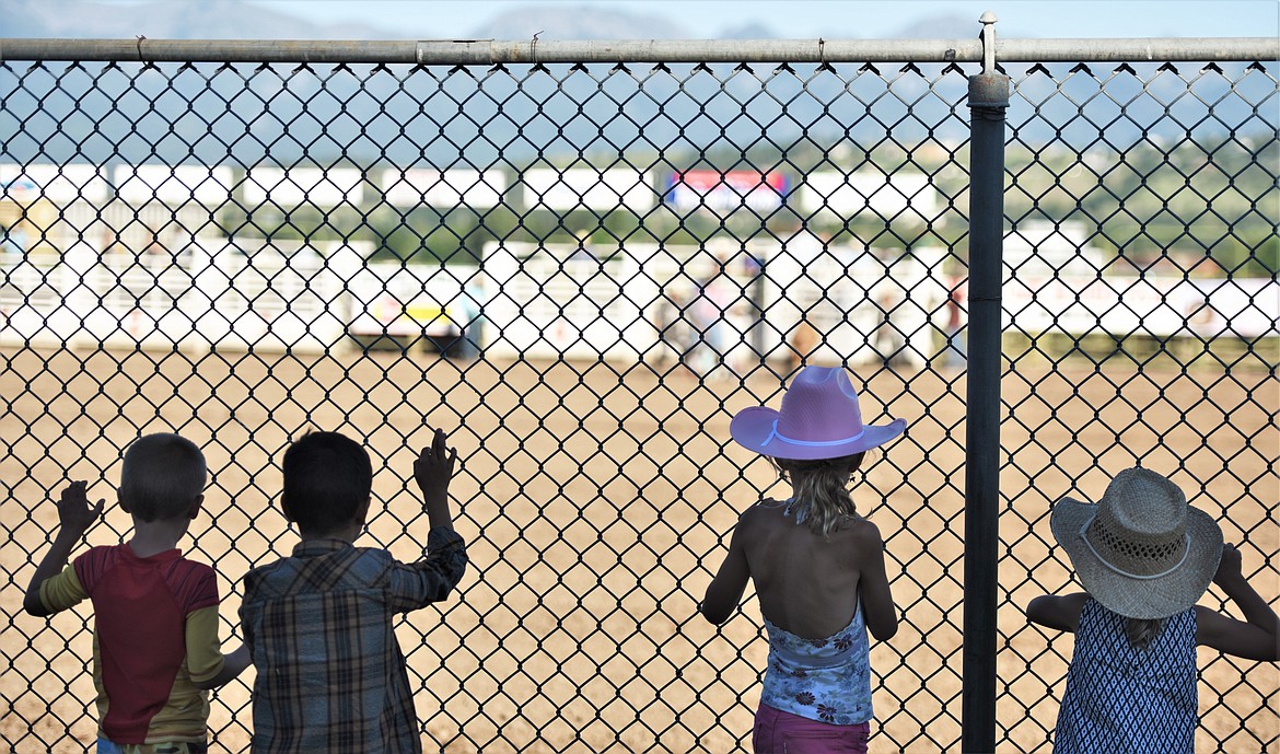 Young Mission Mountain Rodeo spectators line the fence of the Les Baldwin Arena. (Scot Heisel/Lake County Leader)