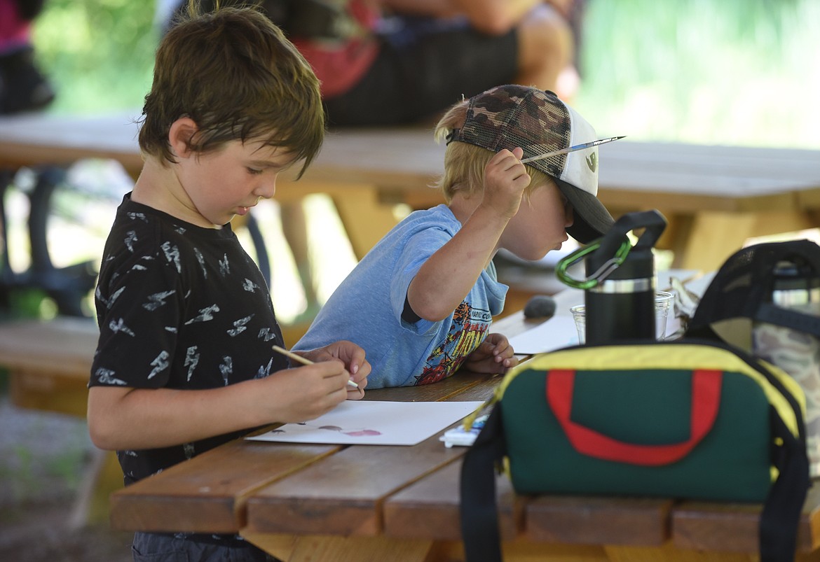 Olin Lillie, 6, left, and his 3-year-old brother, Waylon, work on paintings Tuesday, June 29, 2021, during the Whitefish Legacy Partners painting-from-nature program. It's one of several free programs the organization host during the summer to help children develop an appreciation for nature. (Scott Shindledecker/Daily Inter Lake)