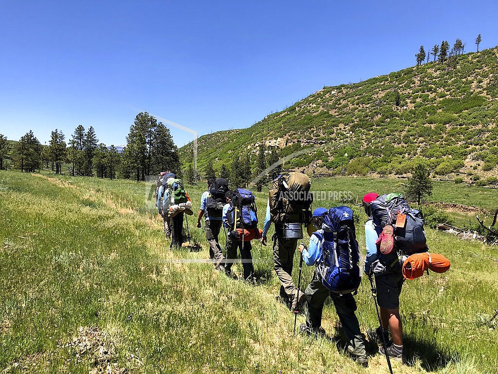 In this June 10, 2021 photo provided by Barry Bedlan, members of Troop 298 of Frisco, Texas are among the first to embark a 12-day trek across the Philmont Scout Ranch, outside Cimarron, N.M. Boy Scout and Girl Scouts’ leadership say their summer camps are full, special events are sold out, and they’re expecting many thousands of families – some new to scouting, some who left during the pandemic – to sign up now that activities are occurring in-person rather than virtually. (Barry Bedlan via AP)