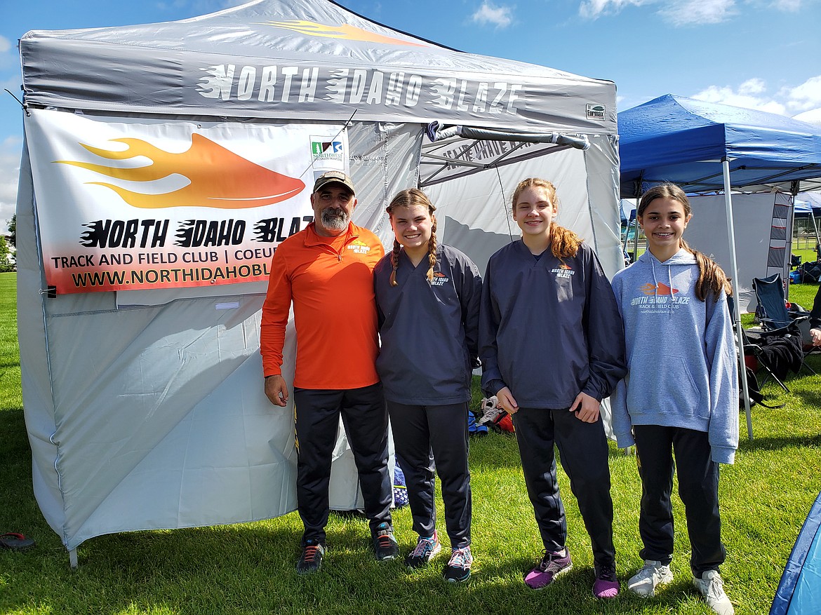 The first North Idaho Blaze track meet was held in Cheney on June 12th. From left: Coach Chris Patterson; Mari Nelson, 14, 100-meter/200-meter sprints; Hazel Kunkel, 14, mid-distance; and Lola Baine, 12, high jump/long jump. All three girls are National Junior Olympic contenders in their respective categories this summer.