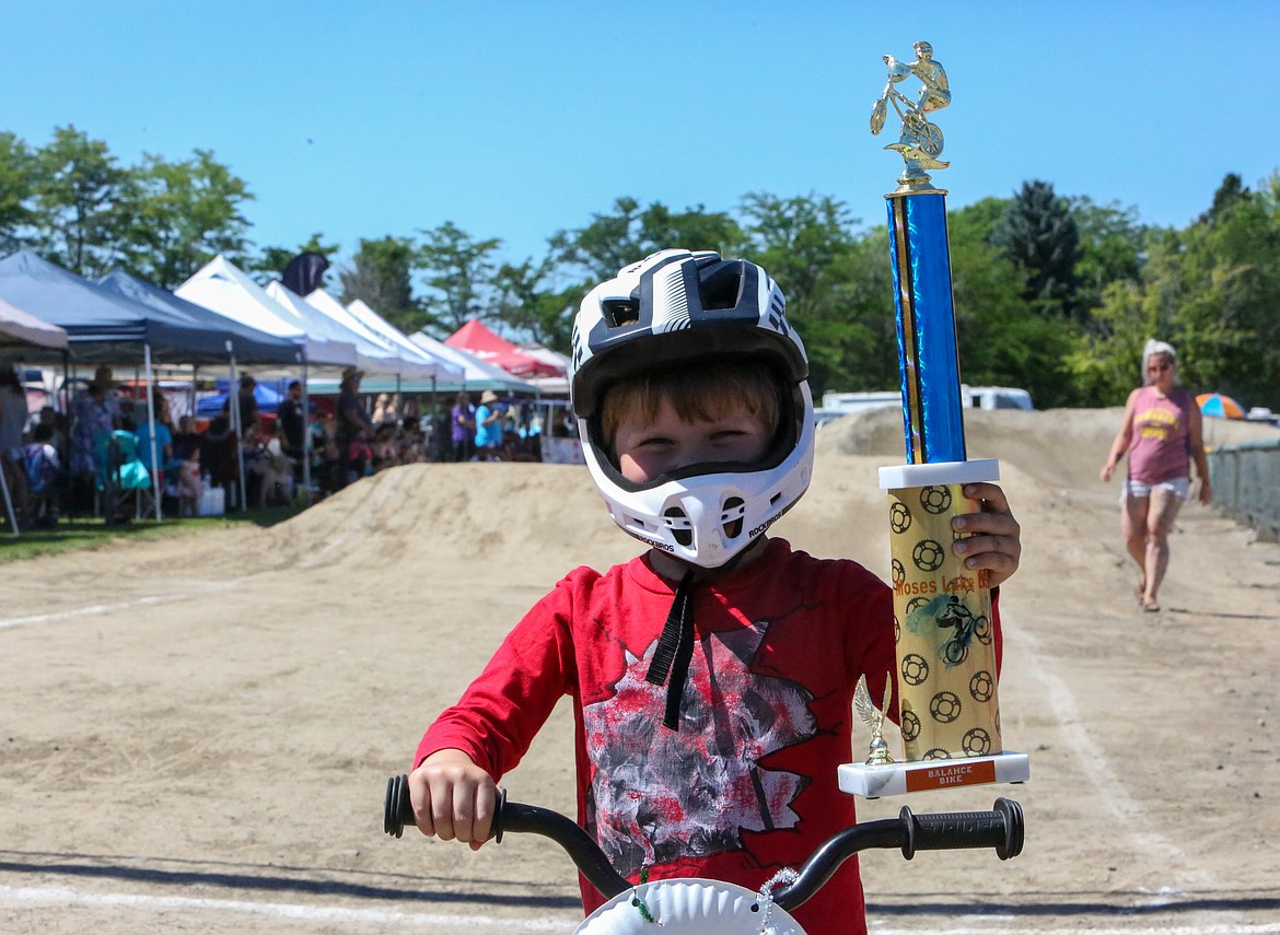 Eric Emerson, 3, holds up his trophy after winning the final race of the strider series Saturday afternoon, June 26, at the Moses Lake BMX track.