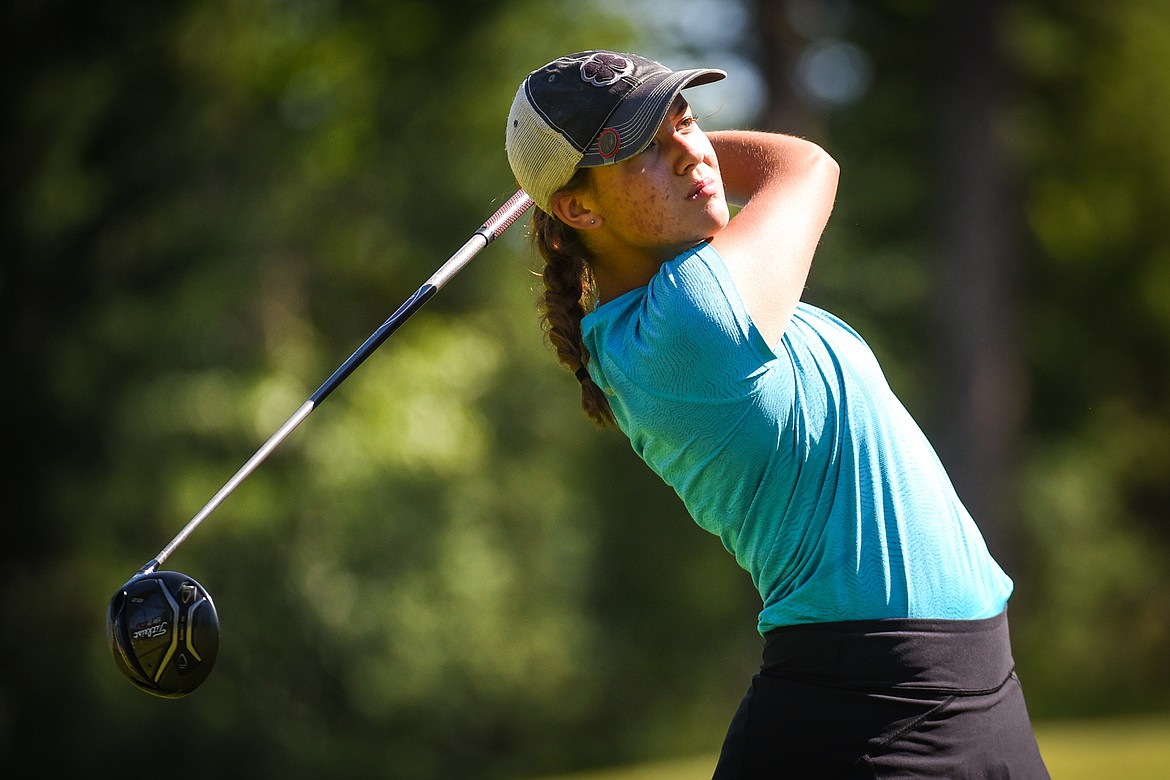 Defending champion Cora Rosanova  watches her drive off the 16th tee of the North Course during the opening round of the Earl Hunt 4th of July Tournament at Whitefish Lake Golf Club on Thursday, July 1. (Casey Kreider/Daily Inter Lake)