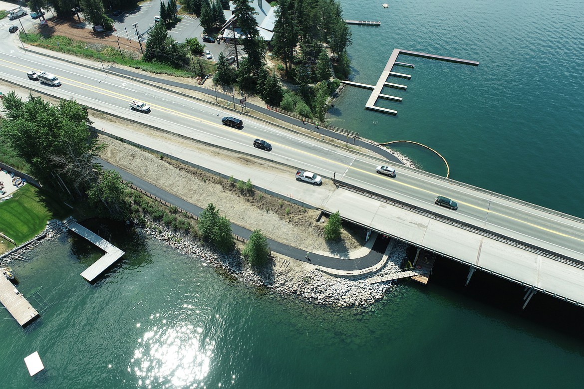 The path underneath the south end of the Long Bridge will reopen late Friday after crews finish installing a railing and the bench following a completion of paving Thursday.