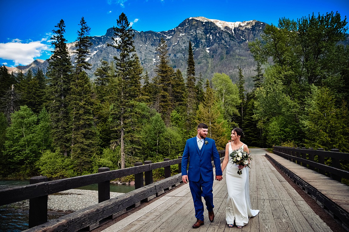 A couple strolls through Glacier National Park during their elopement. (Courtesy of Elope Montana)