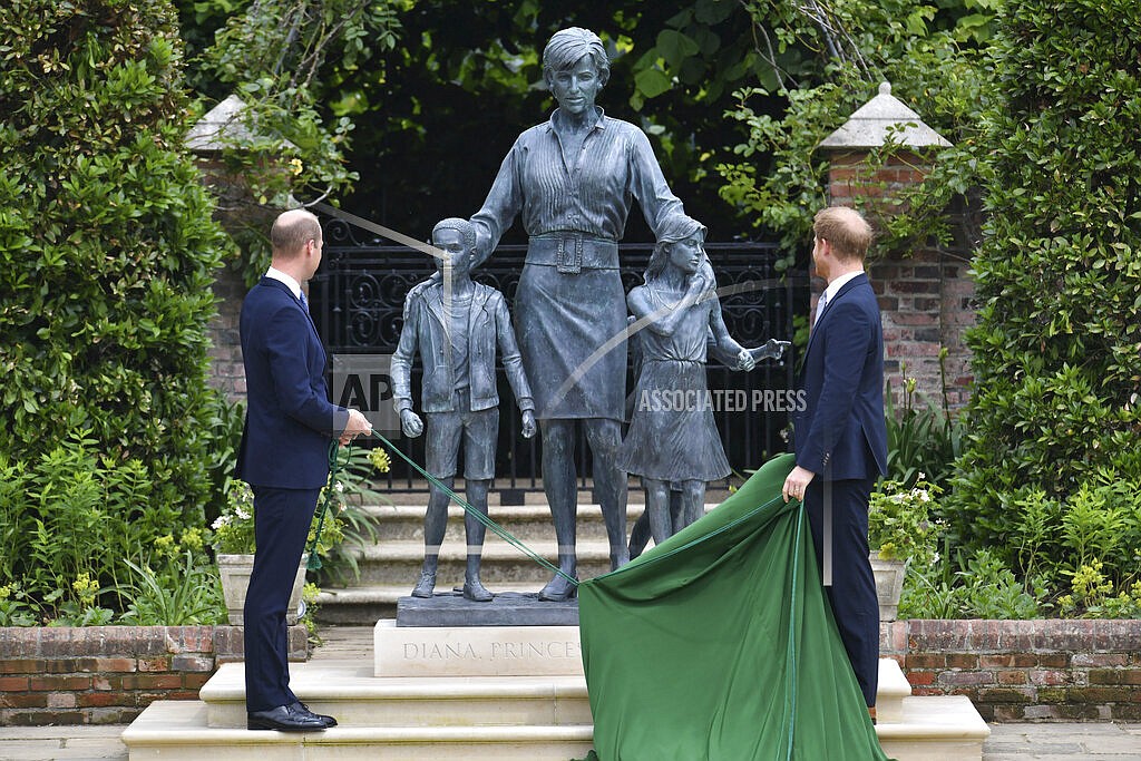 Britain's Prince William, left and Prince Harry unveil a statue they commissioned of their mother Princess Diana, on what woud have been her 60th birthday, in the Sunken Garden at Kensington Palace, London, Thursday July 1, 2021. (Dominic Lipinski /Pool Photo via AP)