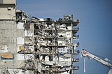 Safety concerns halt rescue efforts at condo collapse site