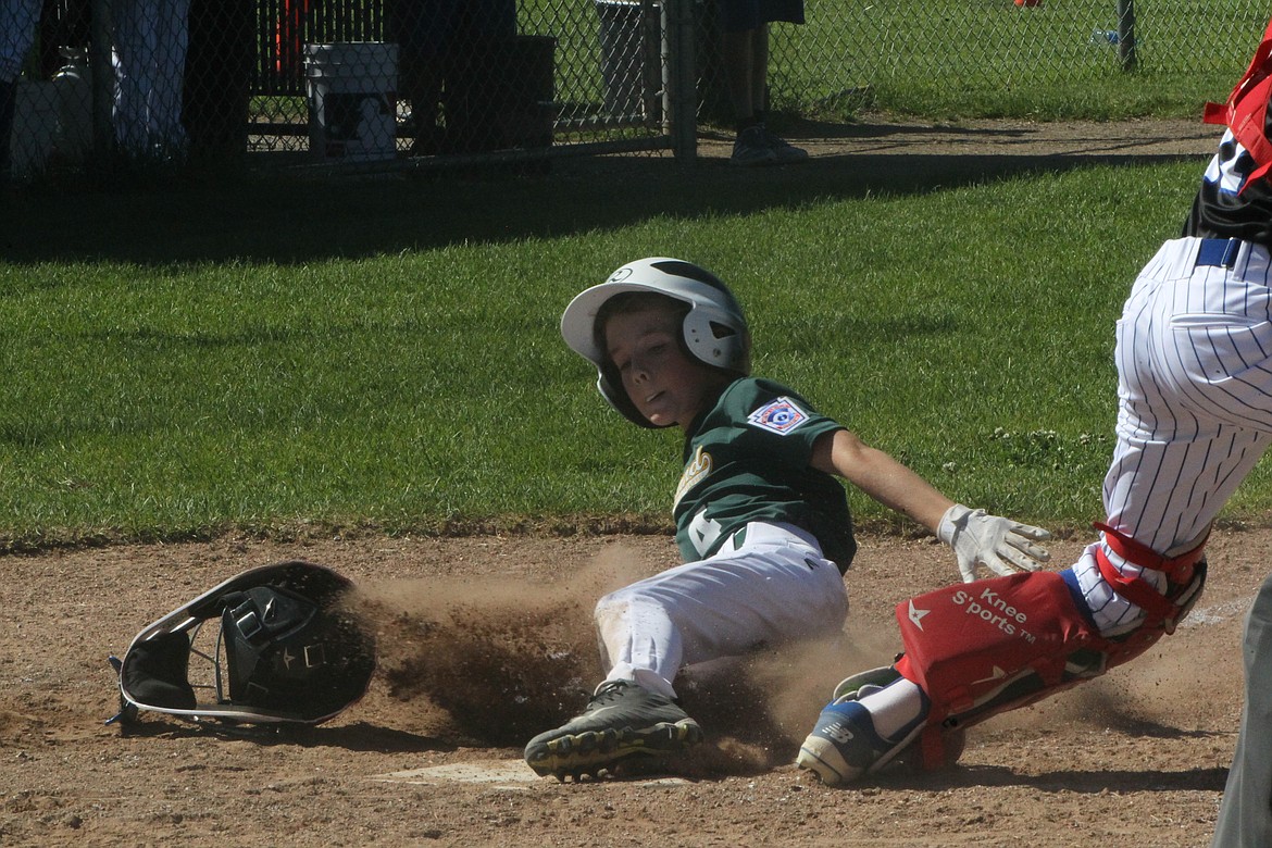 MARK NELKE/Press
Ben Rowberge of Lakeland slides home with an apparent run vs. Coeur d'Alene in a Little League Majors District 1 baseball tournament game Friday at the Canfield Sports Complex. Alas, the run did not count.