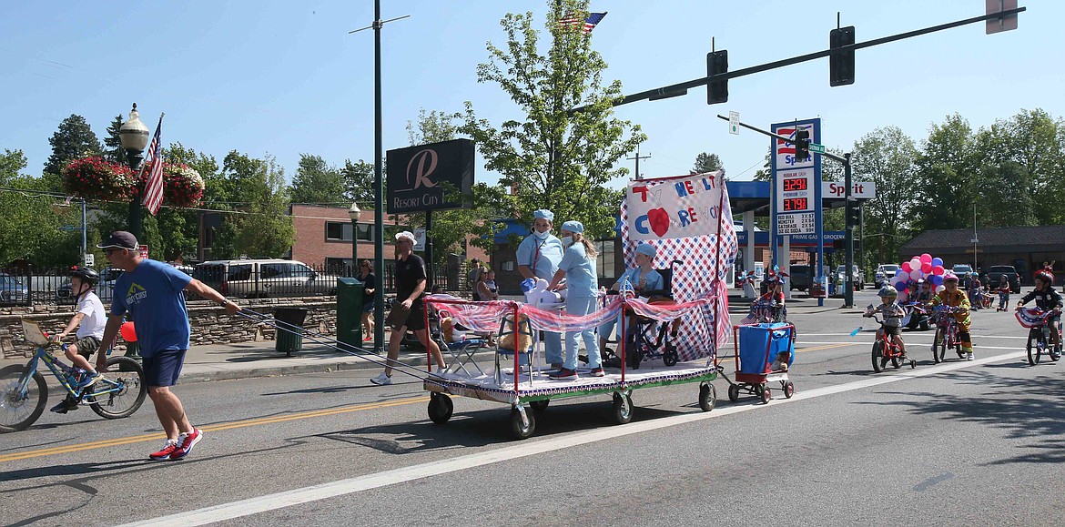 Tristan Riplinger, Shannon Riplinger and Anna Graupman salute America's doctors and nurses with their "Thank you health care workers" float in the Kiddies Parade on Friday.